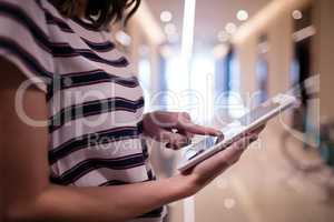 Side view of businesswoman using digital tablet