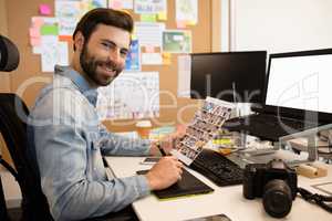 Professional designer working at desk in creative office