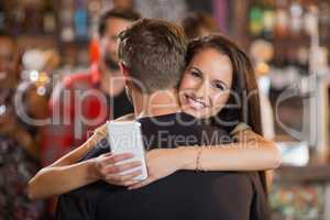 Smiling woman hugging her boyfriend