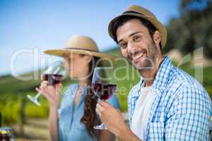 Portrait of smiling man holding red wine