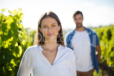 Young woman standing at vineyard