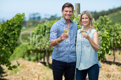 Portrait of happy young couple holding wineglasses