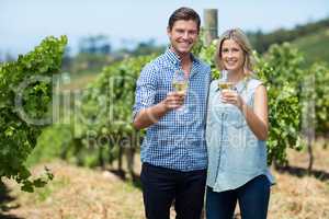 Portrait of happy young couple holding wineglasses