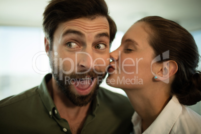 Close up of businesswoman kissing businessman