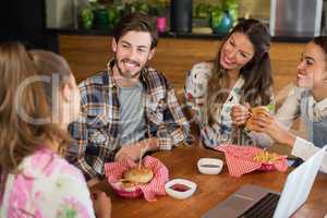 Friends having burger in restaurant