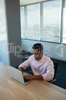 High angle view of businessman typing on laptop