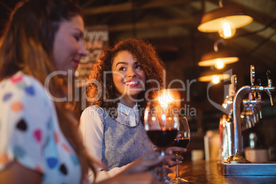 Young women interacting with each other at counter