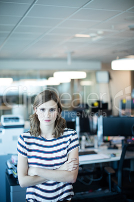 Portrait of young businesswoman with arms crossed