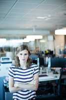 Portrait of young businesswoman with arms crossed