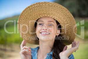 Portrait of happy woman wearing sun hat