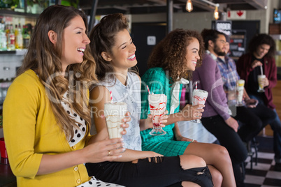 Friends drinking smoothie at restaurant