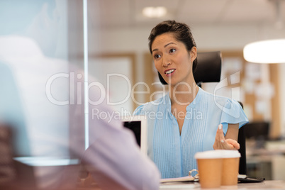 Businesswoman discussing with colleague in office