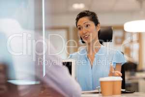 Businesswoman discussing with colleague in office