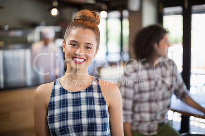 Young woman standing in restaurant