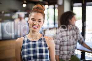 Young woman standing in restaurant