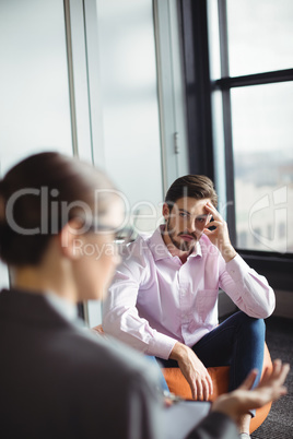 Unhappy man consulting counselor