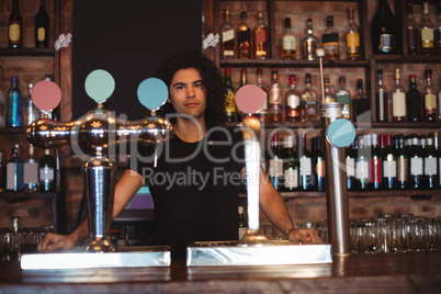 Male bar tender at bar counter