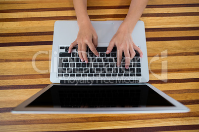 Child using laptop in kitchen