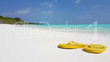 v02427 Maldives beautiful beach background white sandy tropical paradise island with blue sky sea water ocean 4k yellow flip flops