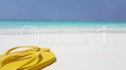 v02931 Maldives beautiful beach background white sandy tropical paradise island with blue sky sea water ocean 4k yellow flip flops