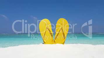 v02937 Maldives beautiful beach background white sandy tropical paradise island with blue sky sea water ocean 4k yellow flip flops