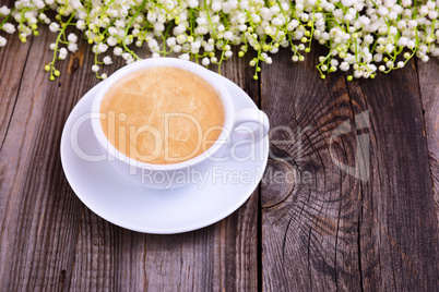 Cup of hot black coffee on a gray wooden surface