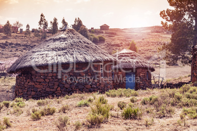 Sunset behind Lesotho huts