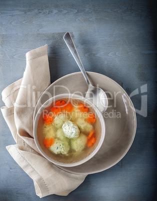 Chicken soup with meatballs and vegetables.