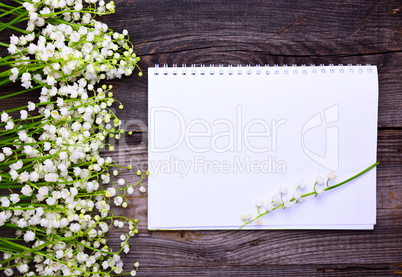 Notebook with clean white sheets on a wooden surface