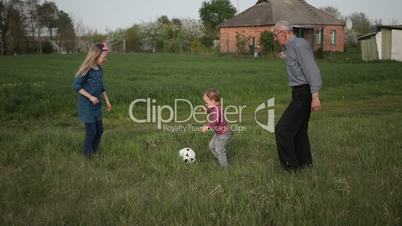 Multi generation family playing soccer together