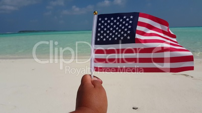 v01101 Maldives beautiful beach background white sandy tropical paradise island with blue sky sea water ocean 4k hand holding us american flag