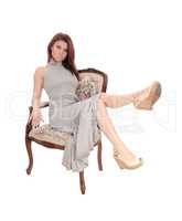 Pretty woman sitting in armchair.