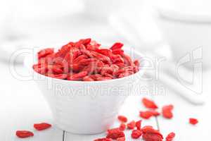 Goji berries in bowl on white background