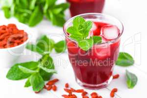 Healthy detox drink with goji berries infused in water with ice, cold refreshing beverage