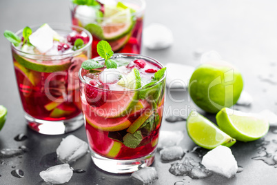 Raspberry mojito cocktail with lime, mint and ice, cold, iced refreshing drink or beverage