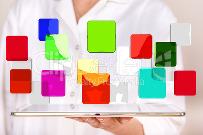 Woman holding tablet pc with colorful glassware