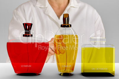Person pointing with finger on perfume bottle