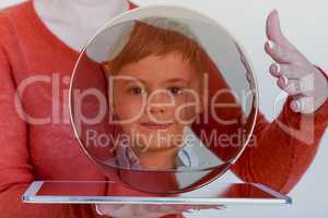 Woman with glass ball and children portrait on tablet pc