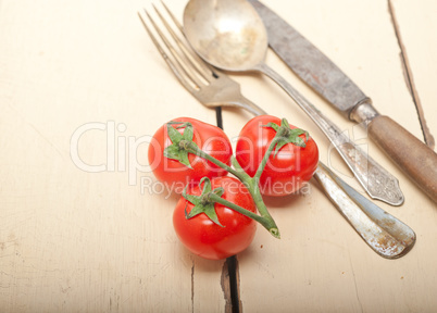 ripe cherry tomatoes over white wood