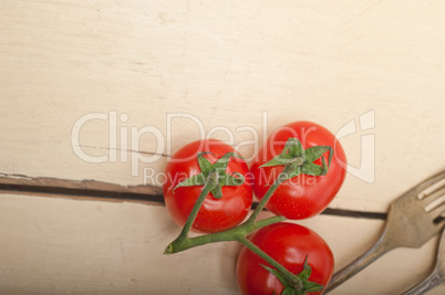ripe cherry tomatoes over white wood
