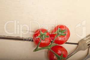 ripe cherry tomatoes over white wood