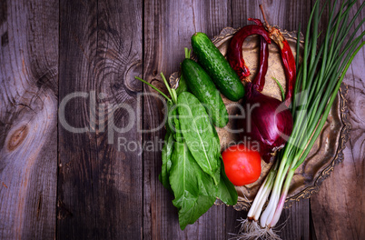 Fresh vegetables on an iron copper plate, gray wooden table