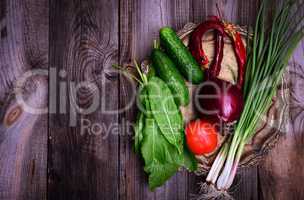 Fresh vegetables on an iron copper plate, gray wooden table