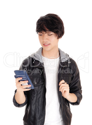 Asian teenager looking at his cellphone.