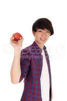 Happy teenager holding red apple.