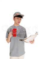 Asian man with coffee and newspaper.