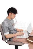 Asian man working at his laptop.