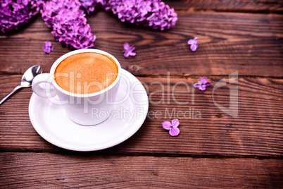 Espresso coffee in a white small cup and saucer