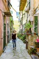 Woman strolling through the city of Levanto on the Ligurian coast
