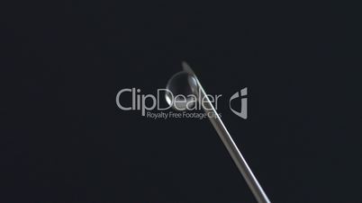 Extreme macro of Syringe needle dripping